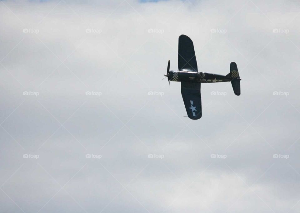 WWII War bird on side in cloudy sky