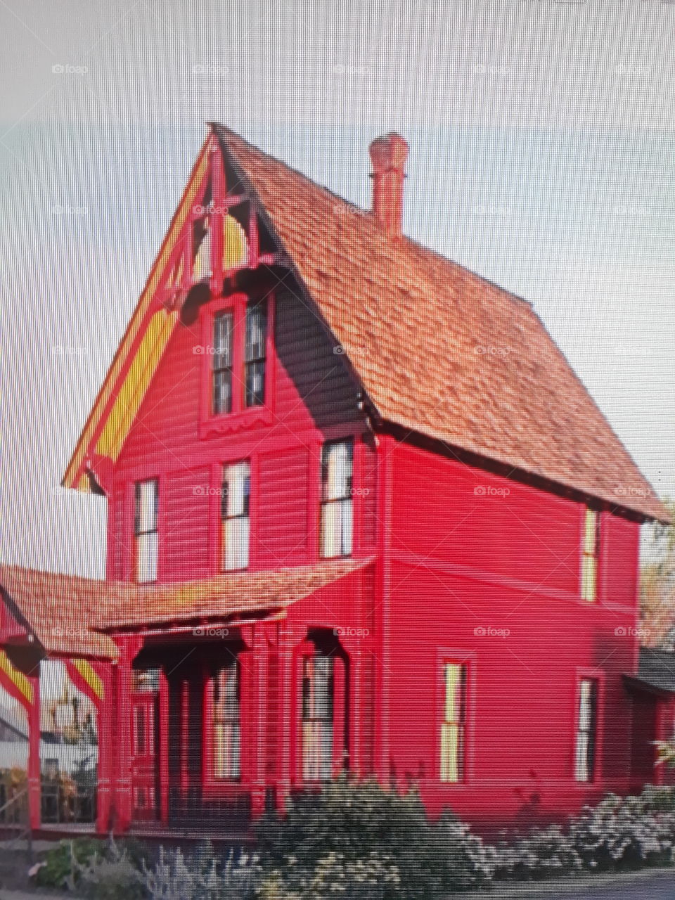 a pretty wooden house with european roof house that everyone would wish for with red paintings