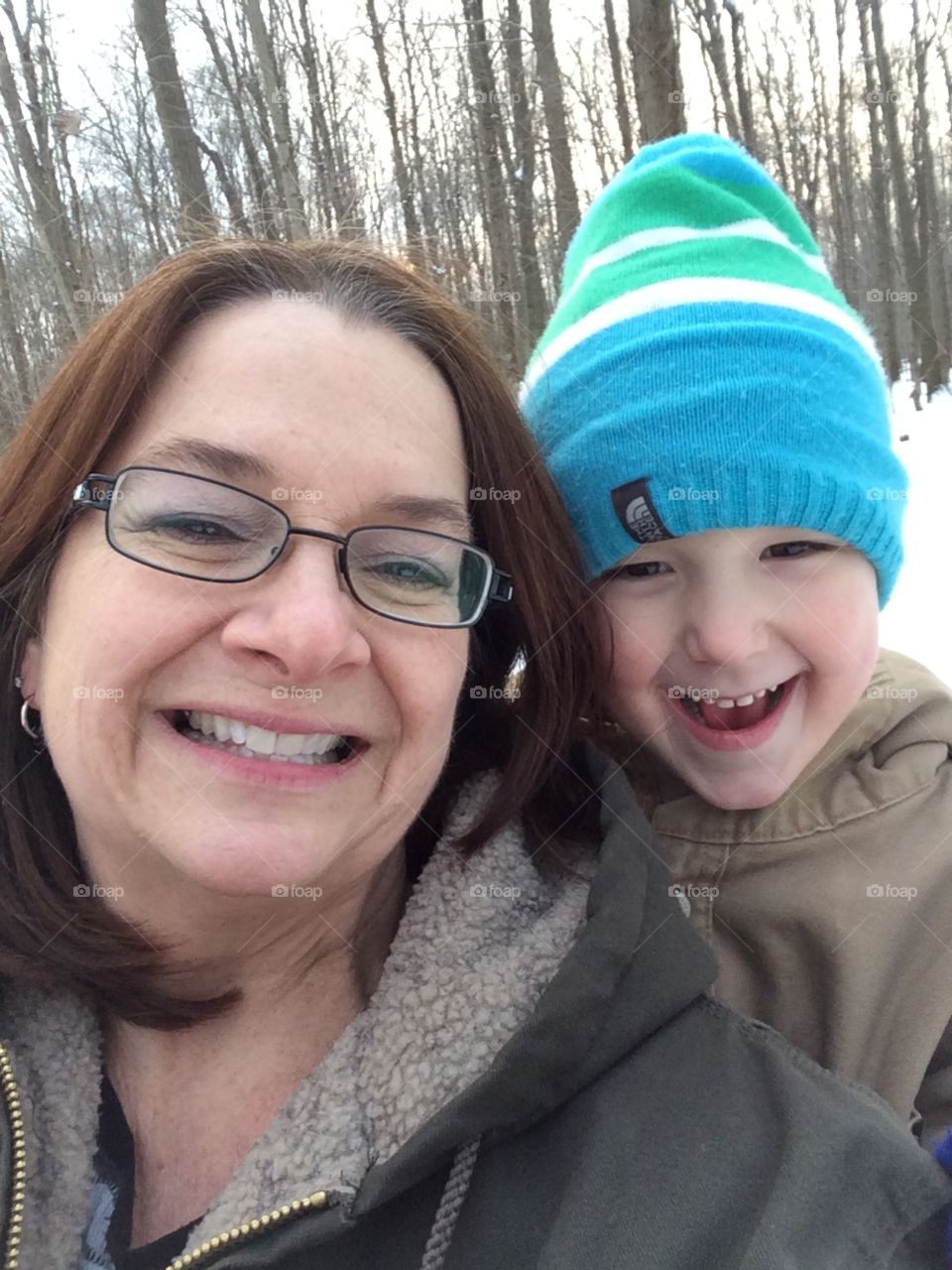 Riding with Grandma. Four wheeling in the winter woods. 