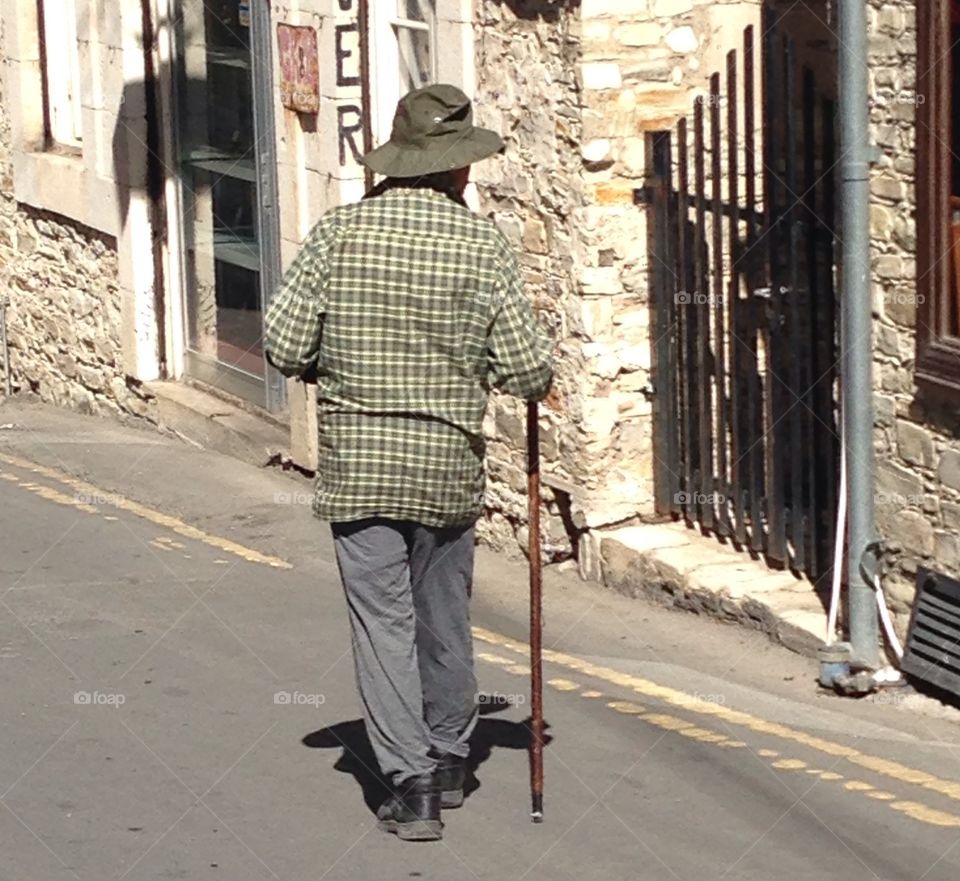 Elderly man walking alone on the street