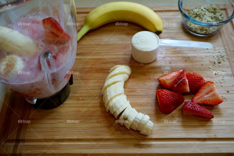 Blender and strawberry banana smoothie ingredients