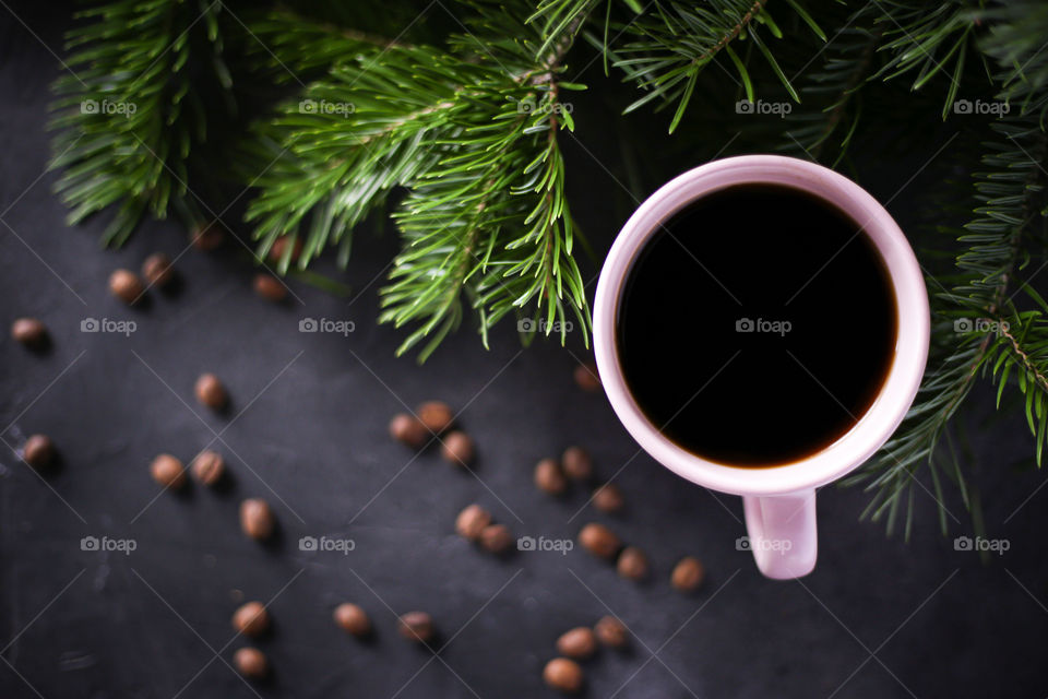 Cup of coffee and Christmas tree branches 