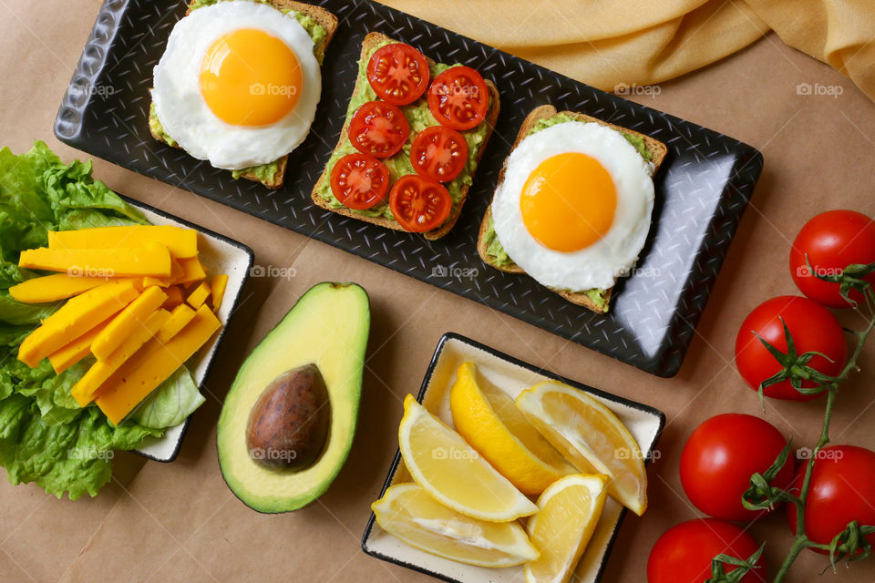 toast with avocado and scrambled eggs for breakfast