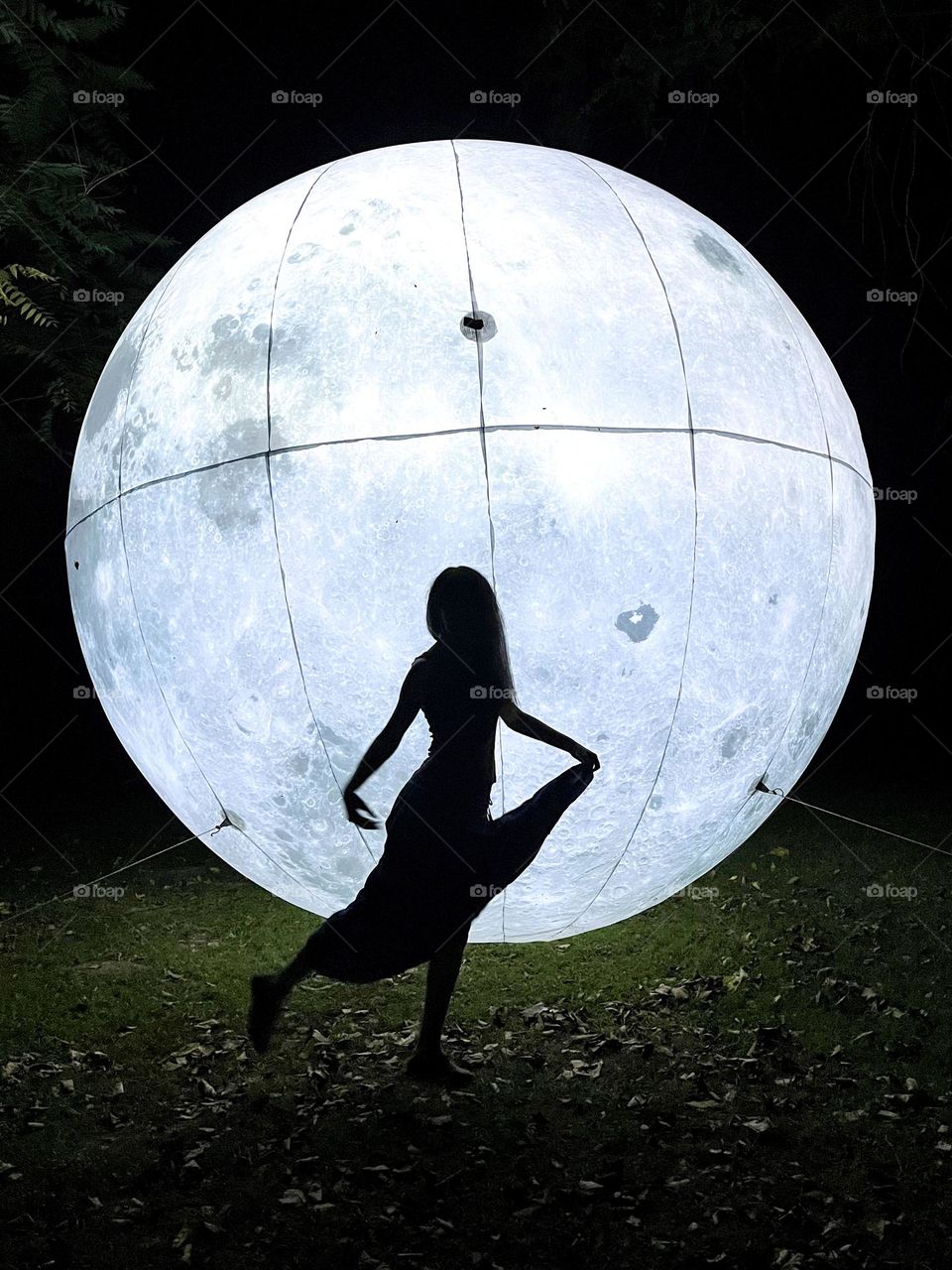 Woman Dancing in Front of the Art Installation Moon