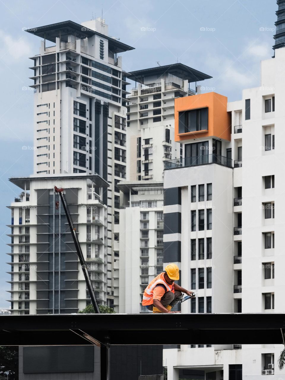 A specialist working on sealing off the roof in a construction site