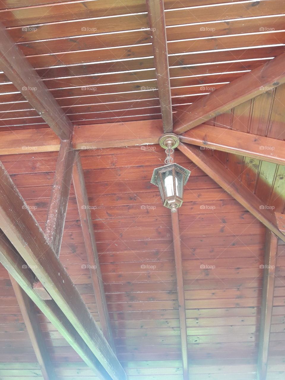 a beautiful exotic wood roof with lamp