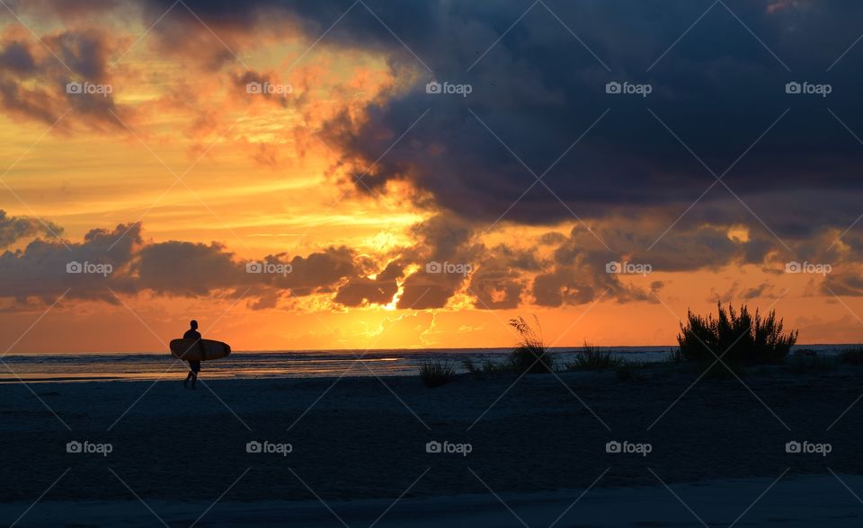 Surfer at sunrise