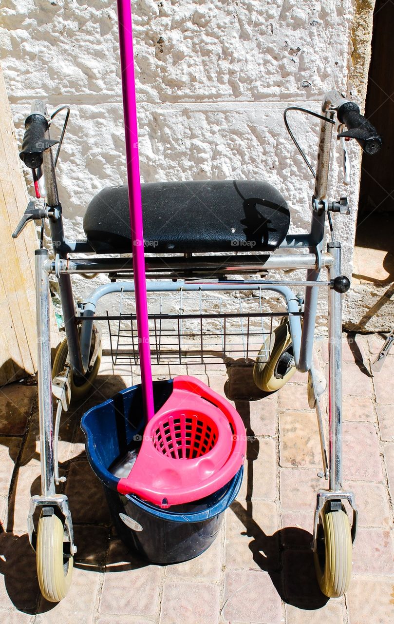 A walking frame and a bucket 