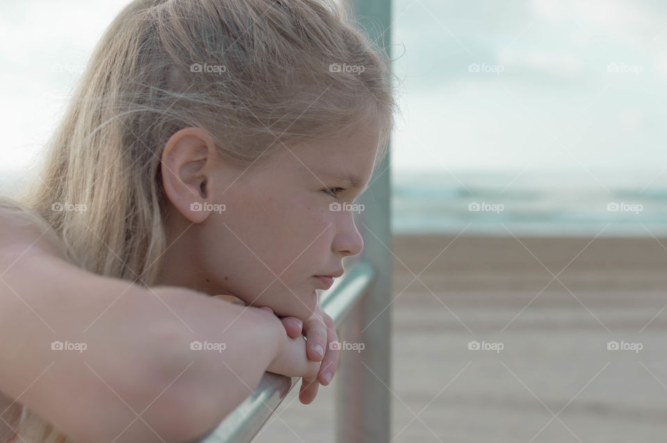 girl on the seaside and looking thoughtly