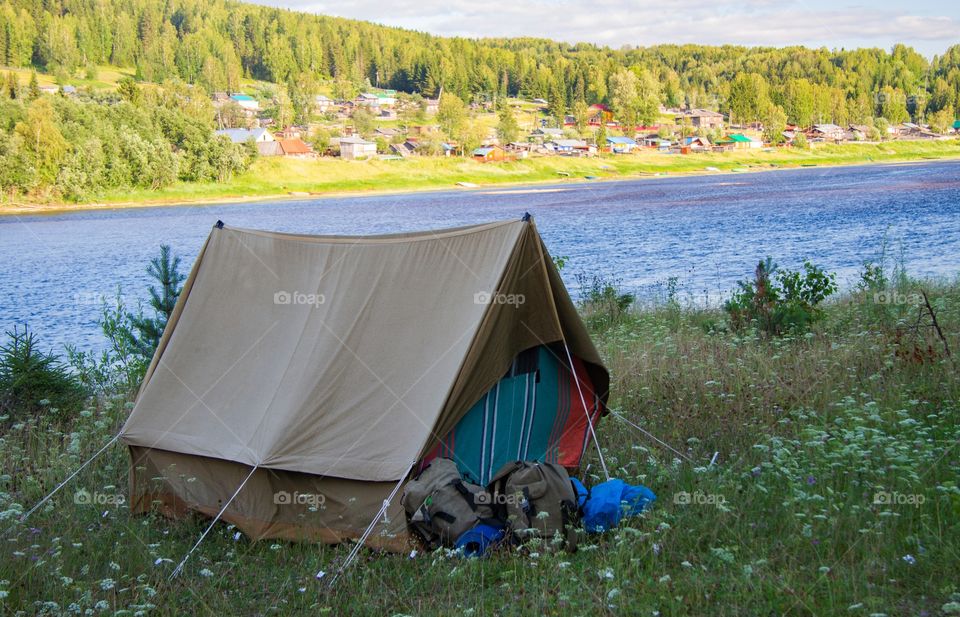 An old canvas tent on the river bank