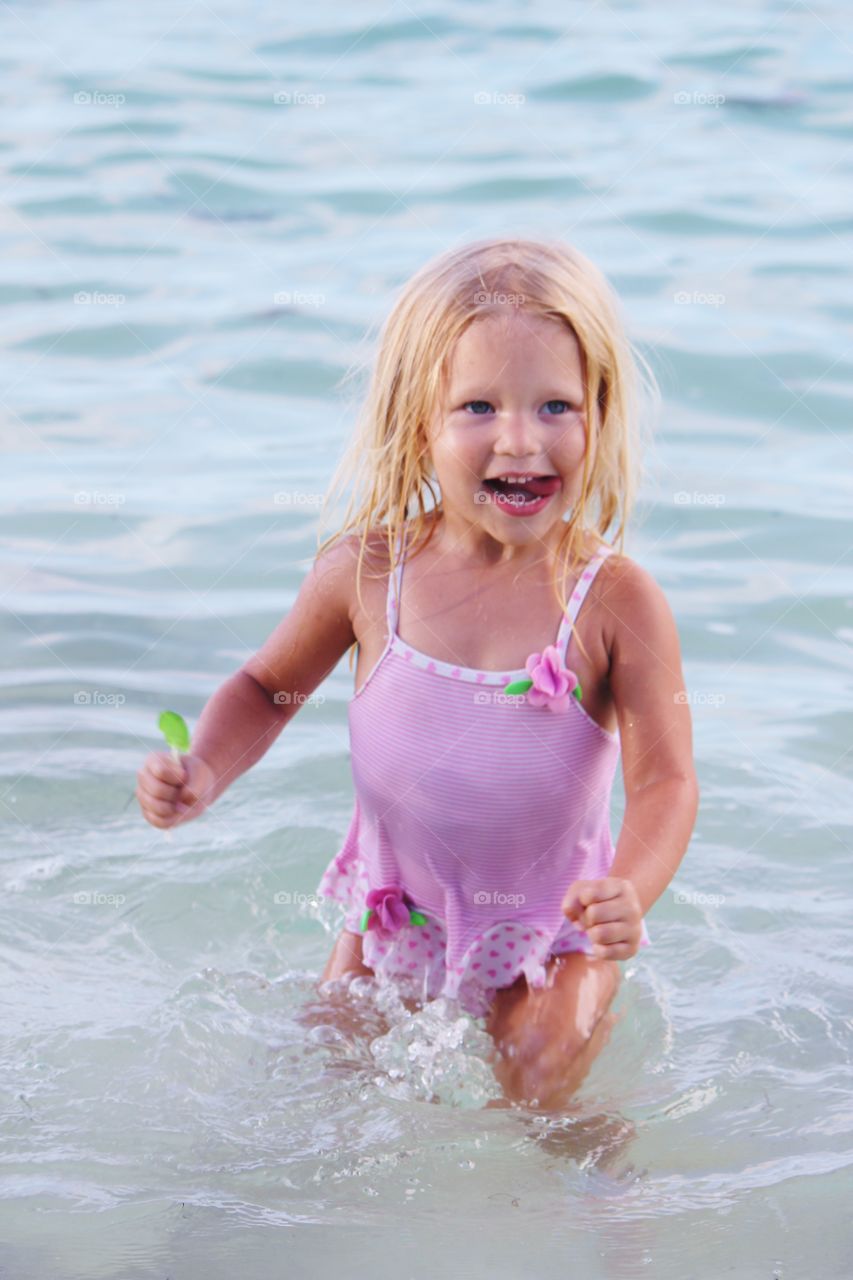 Little girl playing in the ocean