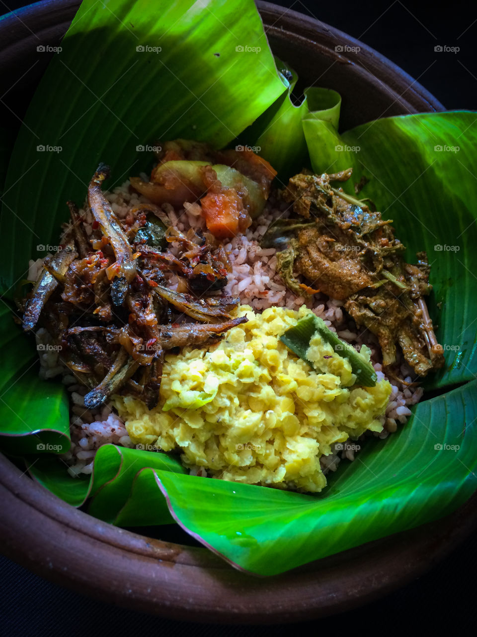 Food in Sri Lanka rice and curry , traditionally served in banana leaf with clay pot .