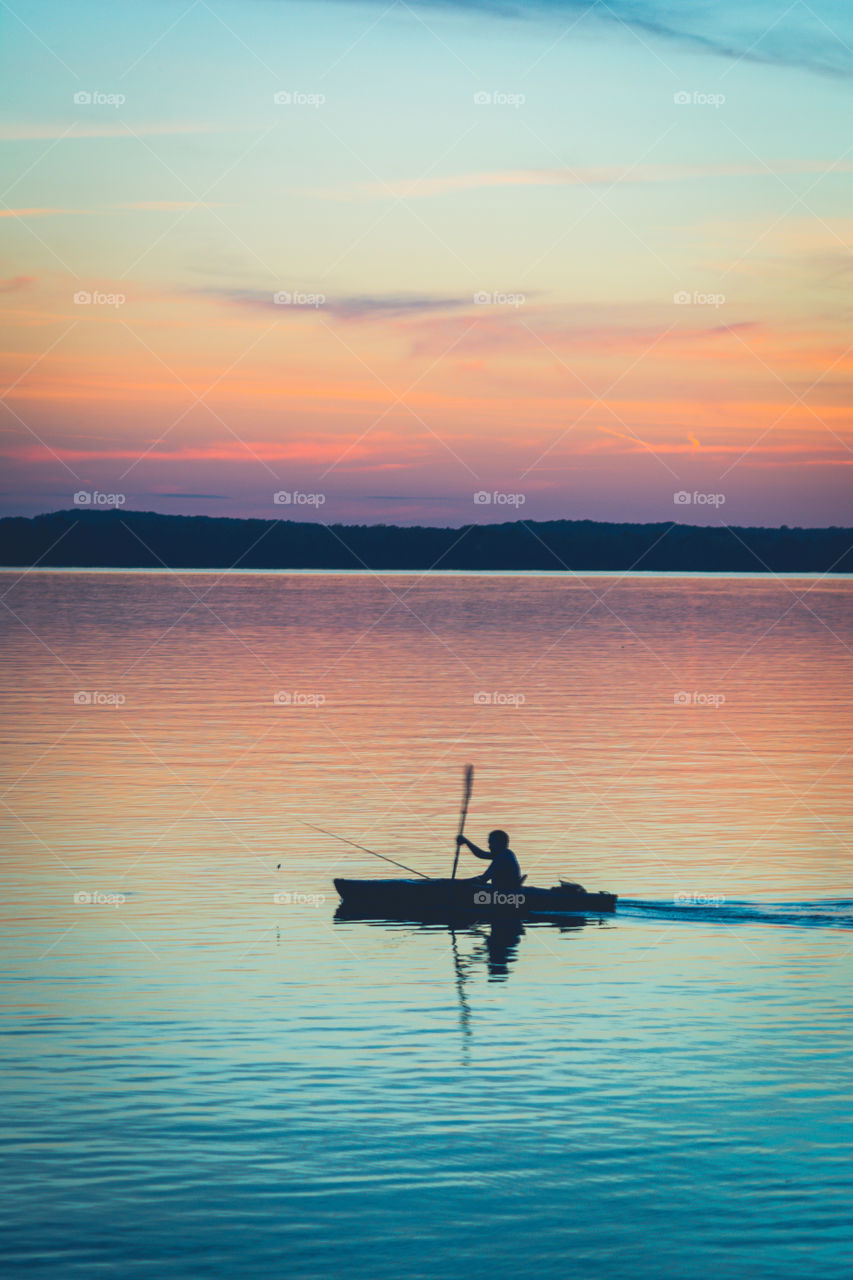 Silhouette of a Kayaker Against a Colorful Late Evening Sky on the Tennessee River