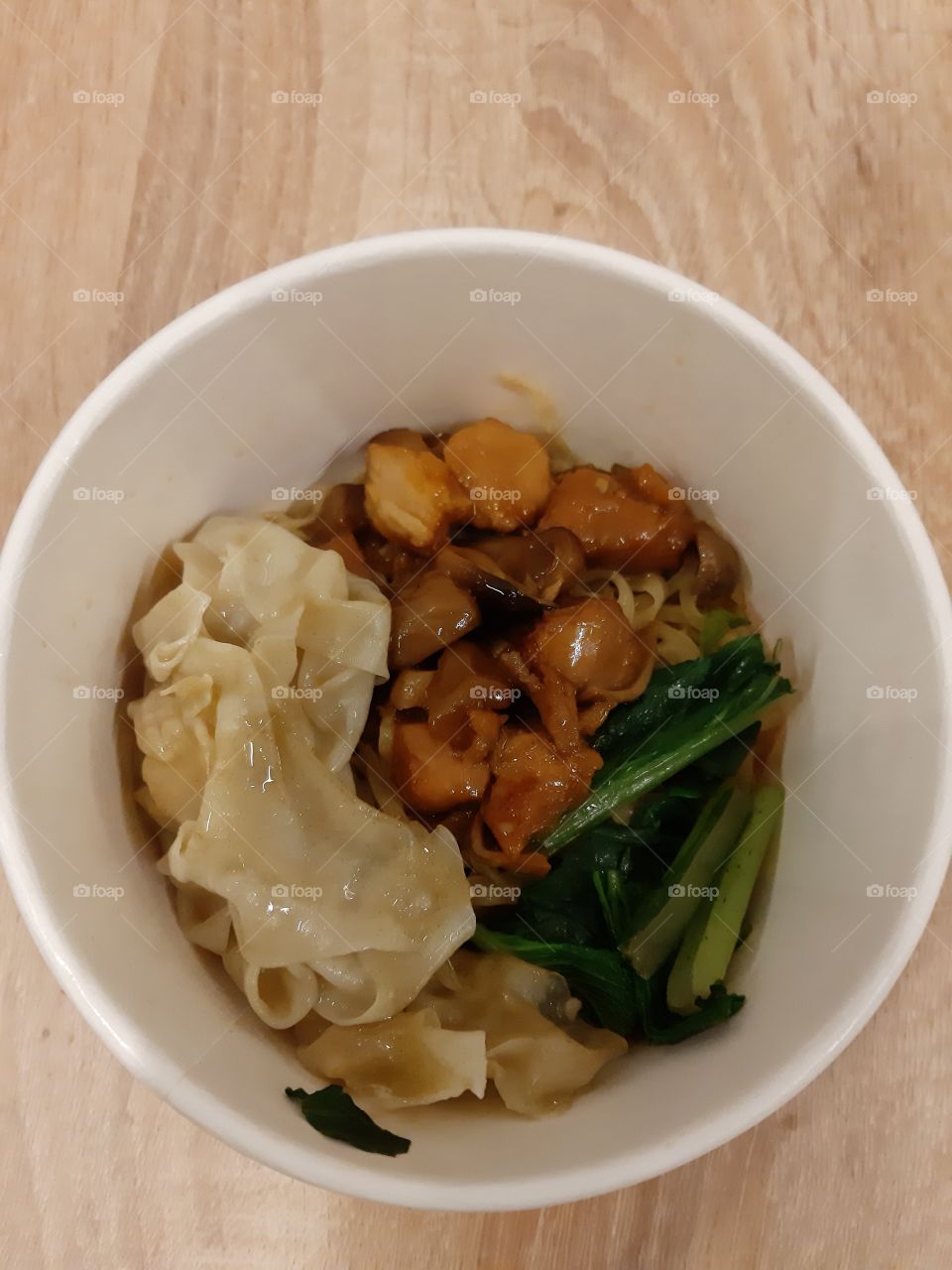 Chicken noodles in a paper bowl