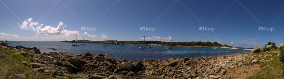 Panoramic beach view on St Agnes, Scilly Isles with boats at anchor