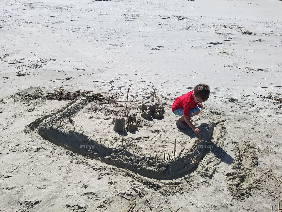 Child building a sandcastle