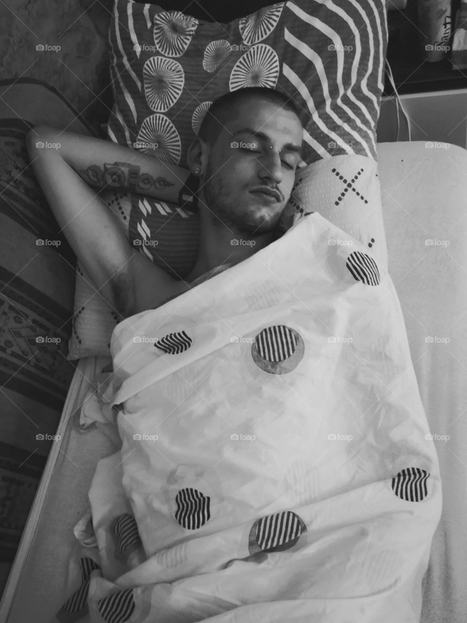 High angle view of a young man sleeping on bed