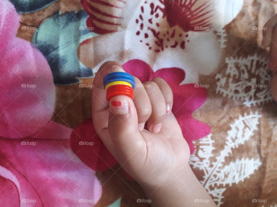 Hand of a small child showing the power of faith, Different colors in child hand.