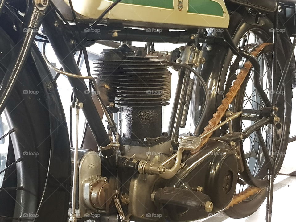 Vintage triumph motorcycle with a leather chain