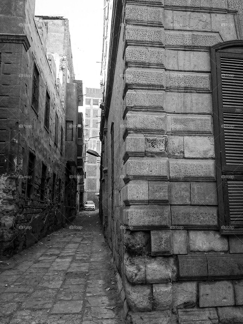 Narrow walking road between old buildings. 