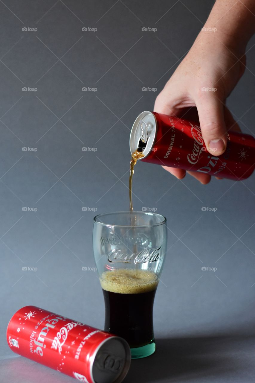 pouring cola in glass