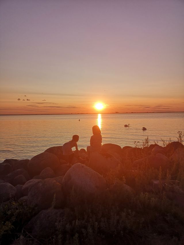 Kids in the sunset by The ocean