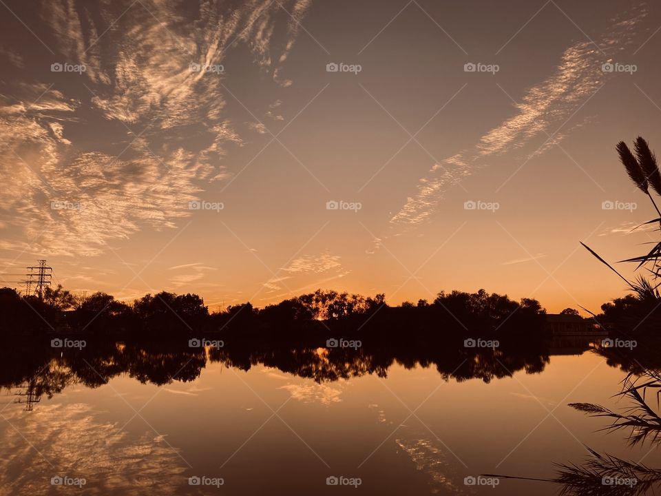 High Clouds add to the Beauty of the Sunset Reflecting and bouncing off the lake water adding to the colours of this gorgeous setting for Sunset.