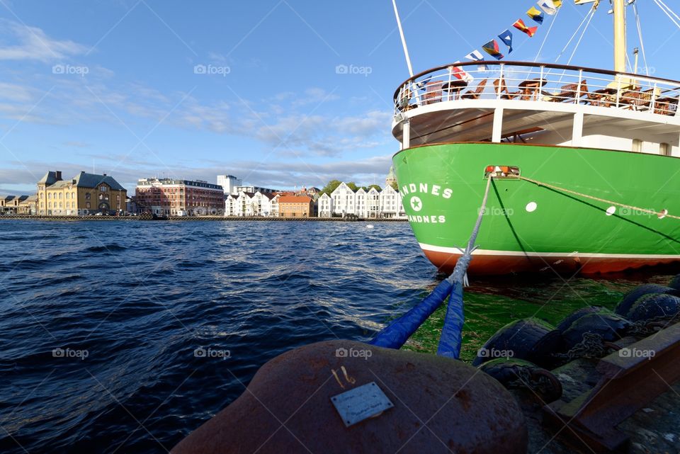 Stavanger harbor, Norway. Boat anchored at the harbor in Stavanger. View of the city in the background.