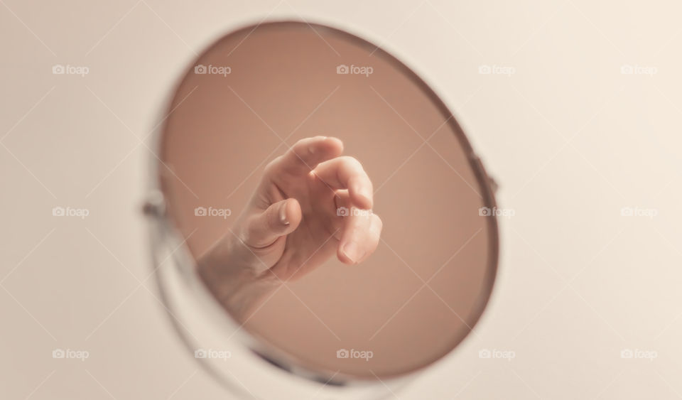 Abstract image made by human hand in mirror.