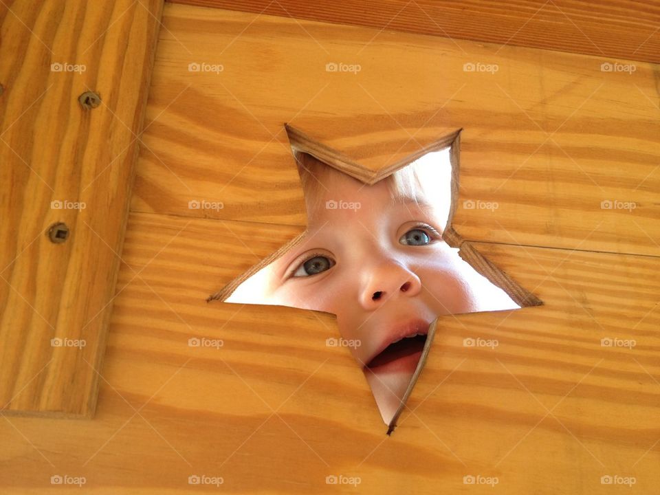 Child looking through a star