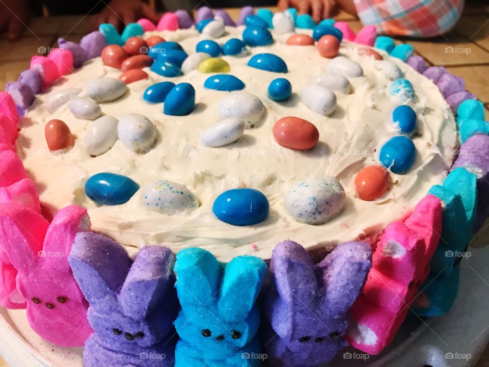 Colorful Peeps bunny cake with robin eggs and white icing