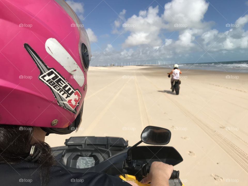Girl racing bike at the beach