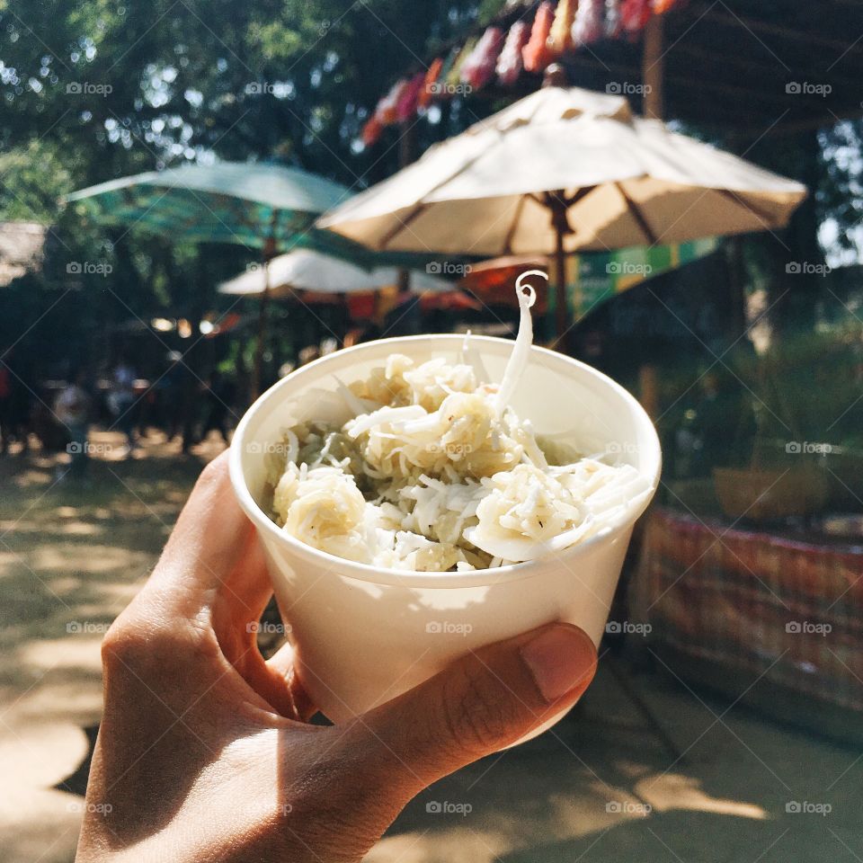 Holding food : Traditional Thai rice and coconut snack 