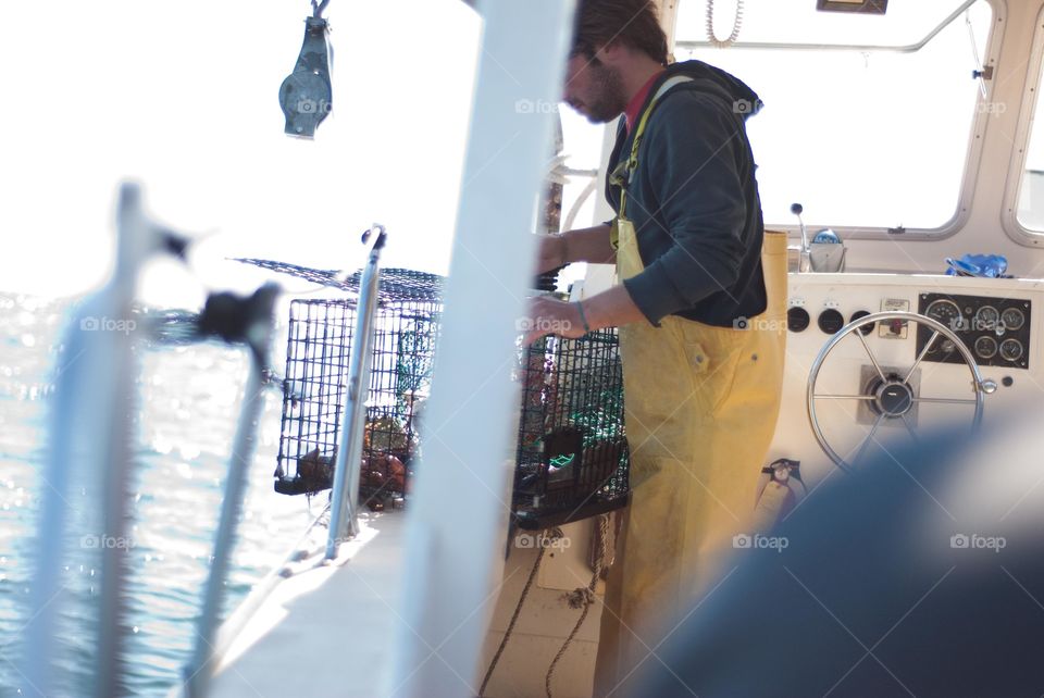 Maine Lobster Fisherman on Boat Pulling Up Trap