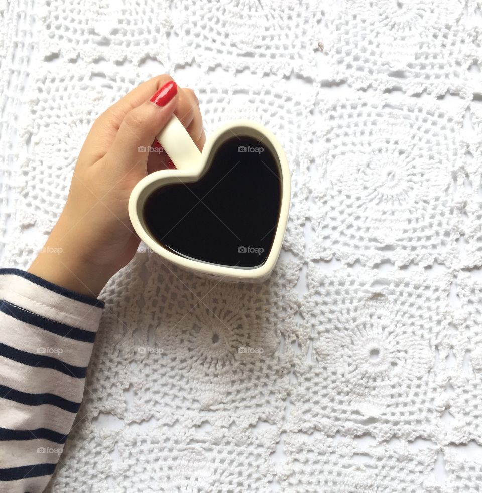 Holding a heart shaped mug
