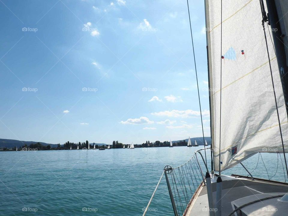 View from the sailing boat on the lake of with blue and bright lights on a sunny day.