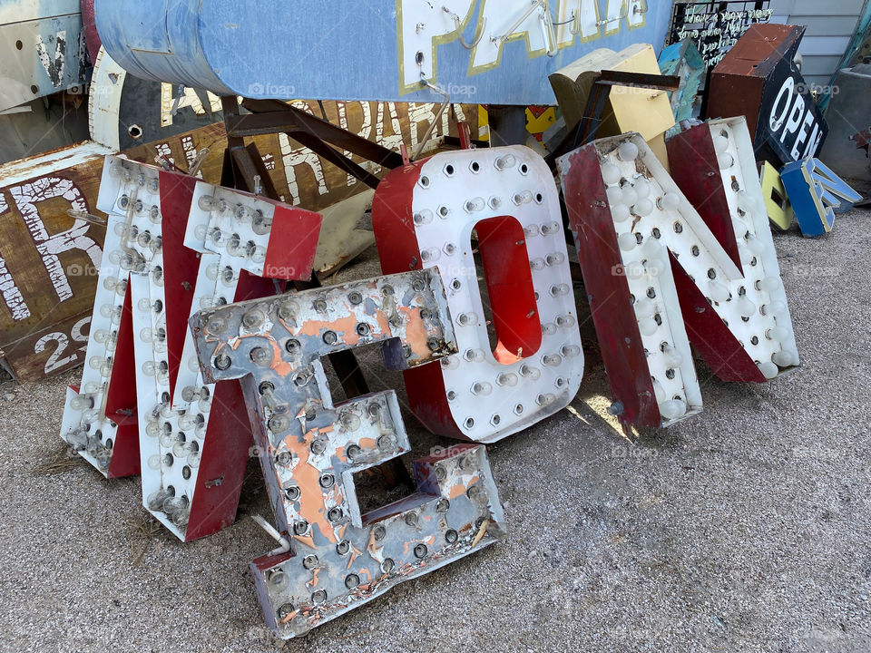 Old abandoned neon sign letters among other junked signs