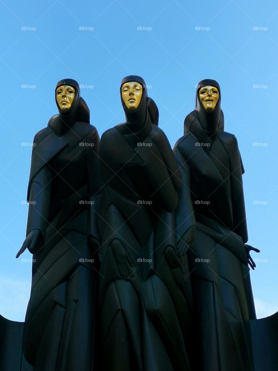 Shooting from the ground up. Sculpture of three women at the national theater of Lithuania, Vilnius.