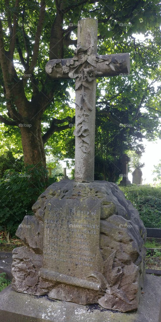 innately carved cross on gravestone