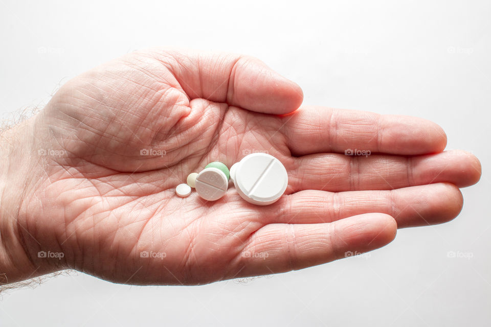 Medicine Pills In Hand Isolated In White Background
