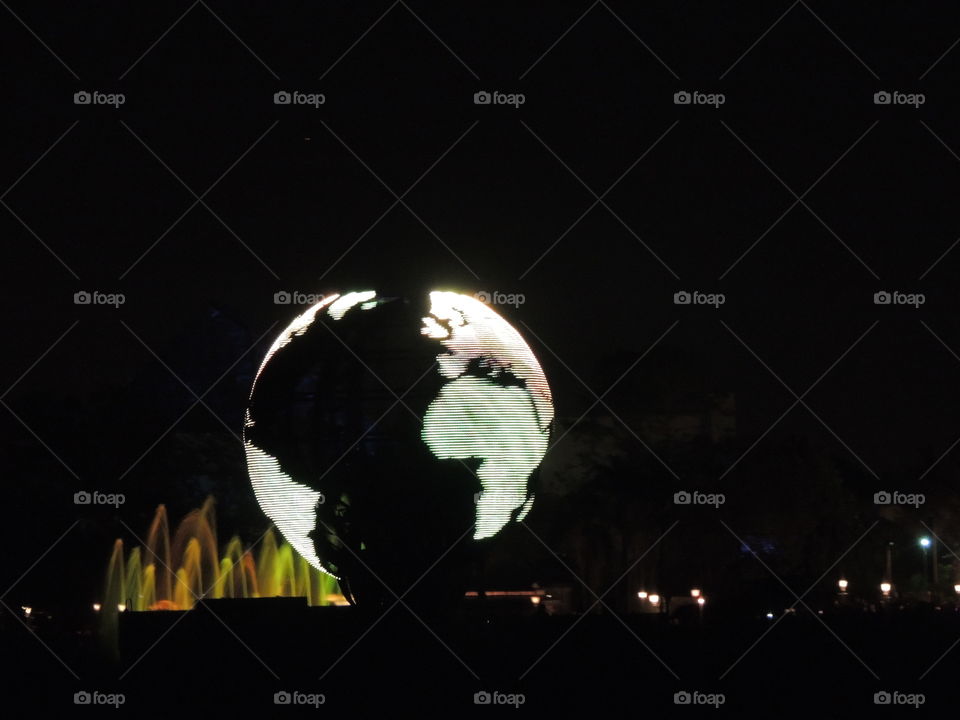 An illuminated Earth makes its way around the World Showcase lagoon during IllumiNations at EPCOT at the Walt Disney World Resort in Orlando, Florida.