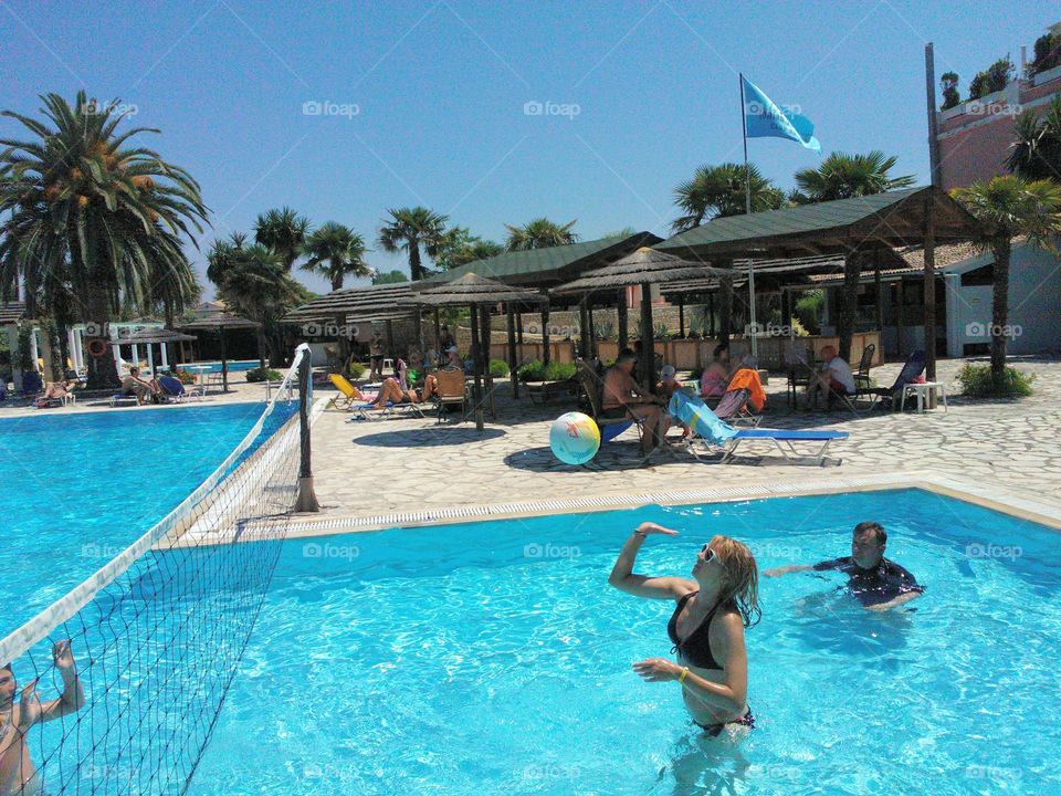 Woman enjoying volleyball in swimming pool