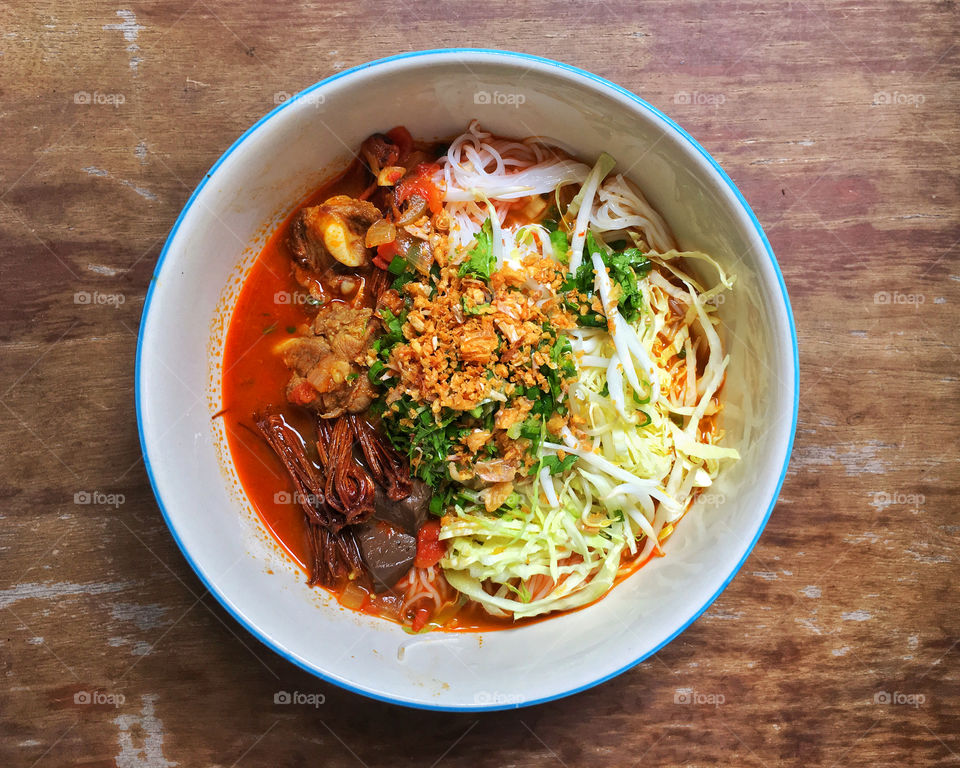 Northern Thai dish made from fermented rice noodles served with pork or chicken blood tofu in a spicy sauce made with pork broth and tomato, crushed fried chilies and dried red kapok flowers.