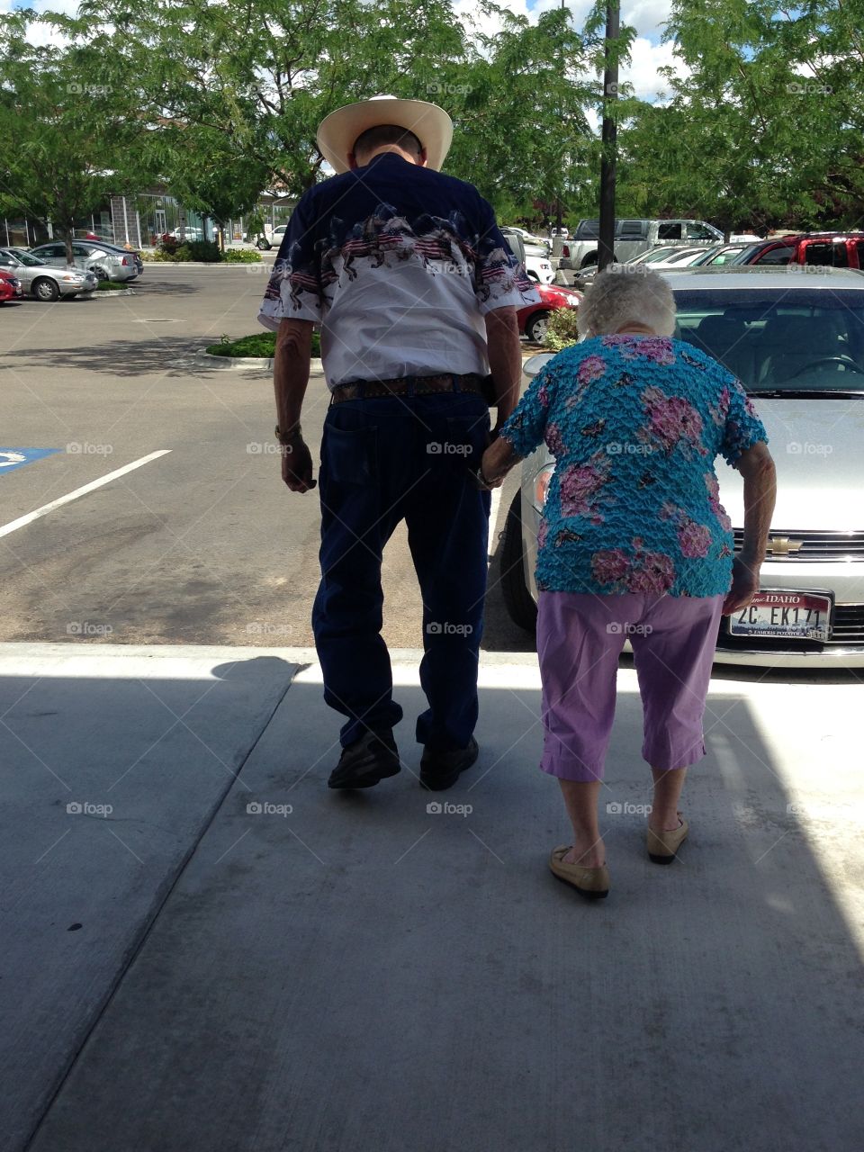 Older gentleman helping his wife to the car