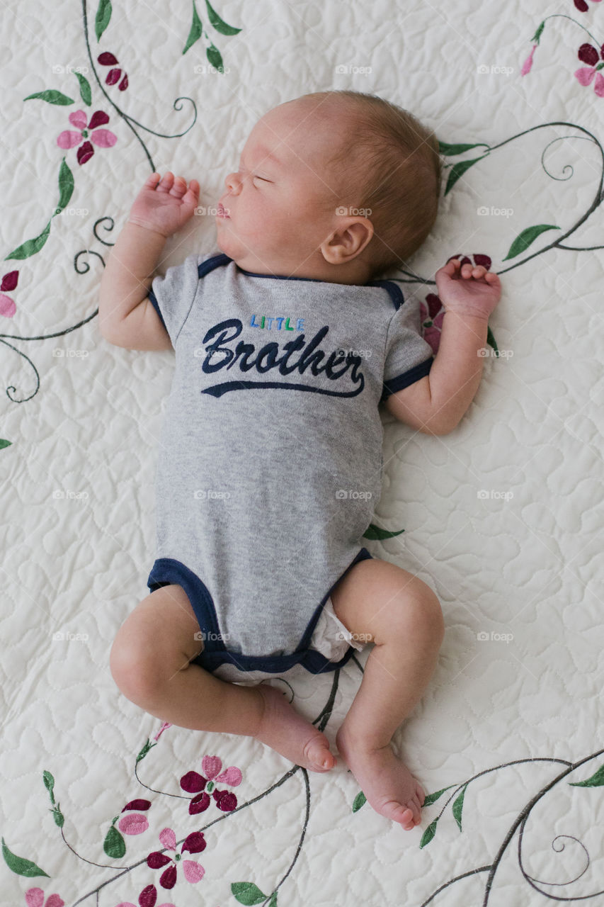 Little baby brother sleeping on blanket 