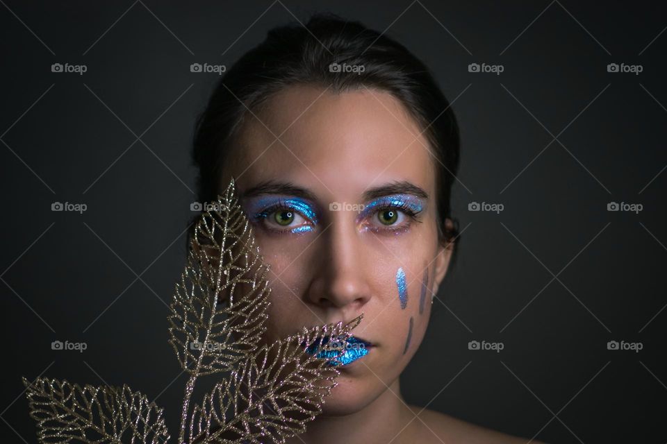 Young woman wearing a make up, eye shadow 