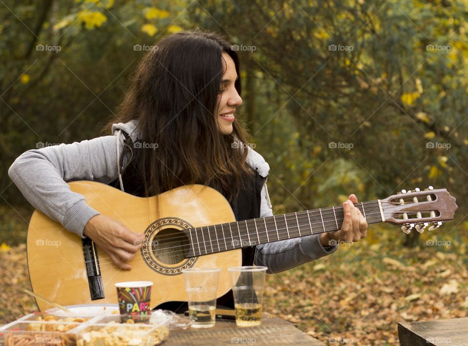 Guitar player woman outdoors