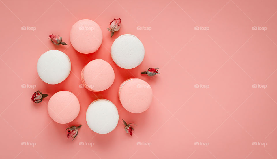 Seven assorted macarons on pastel background. Copy space.