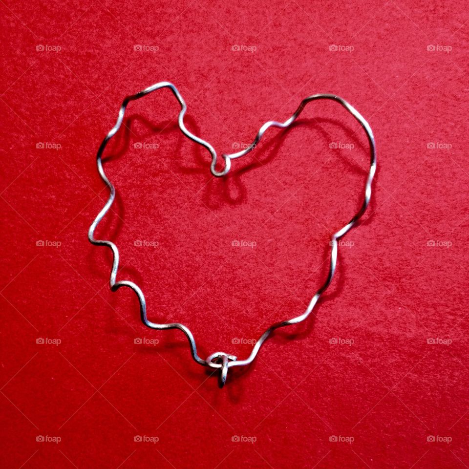 Heart shape against red background