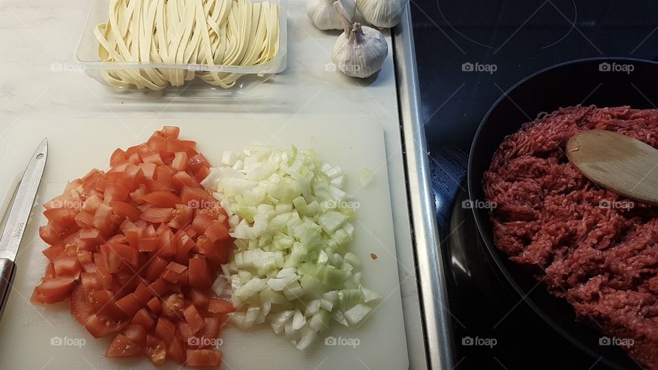 Making pasta with meat sauce 